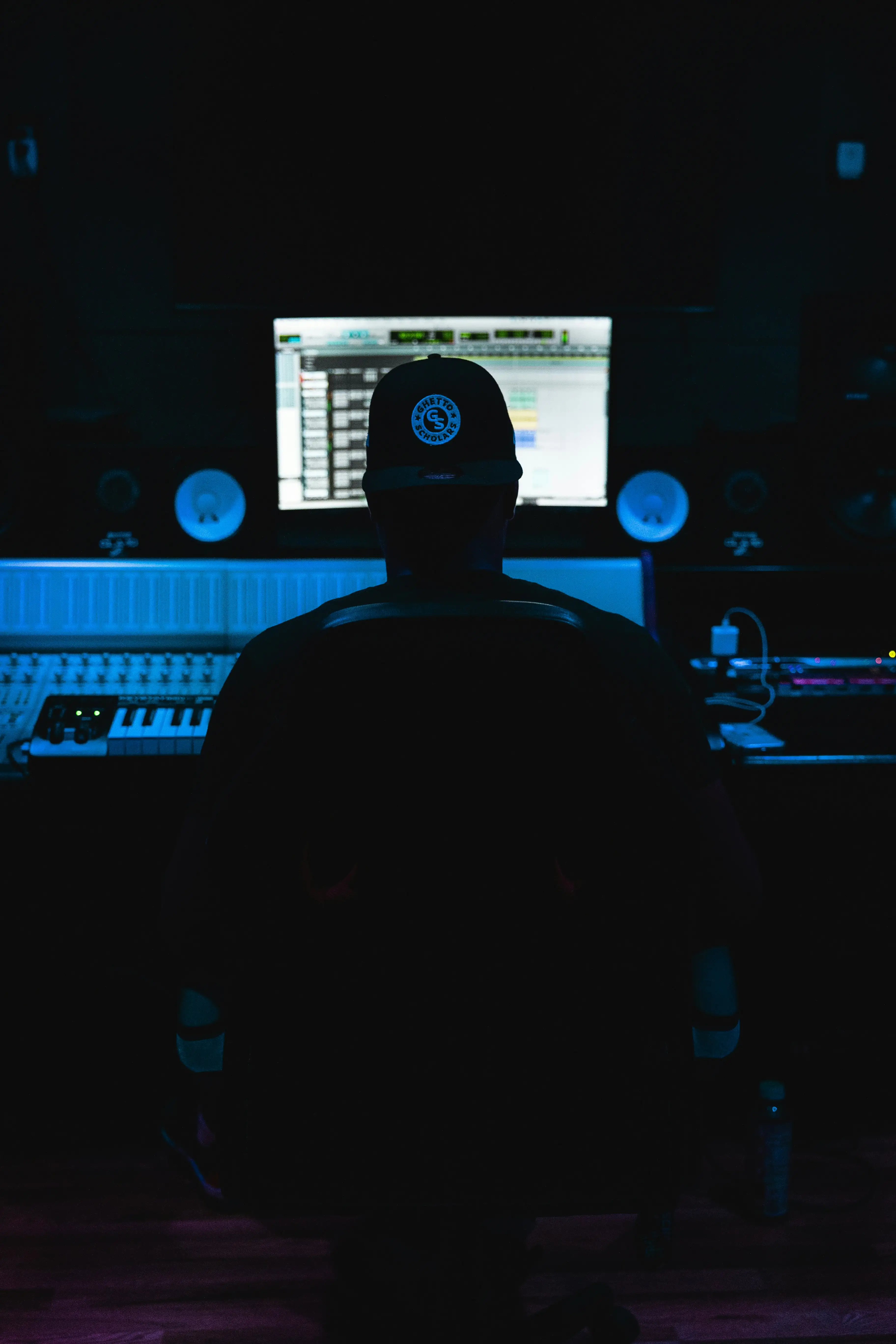 a man sitting in front of a mixing desk